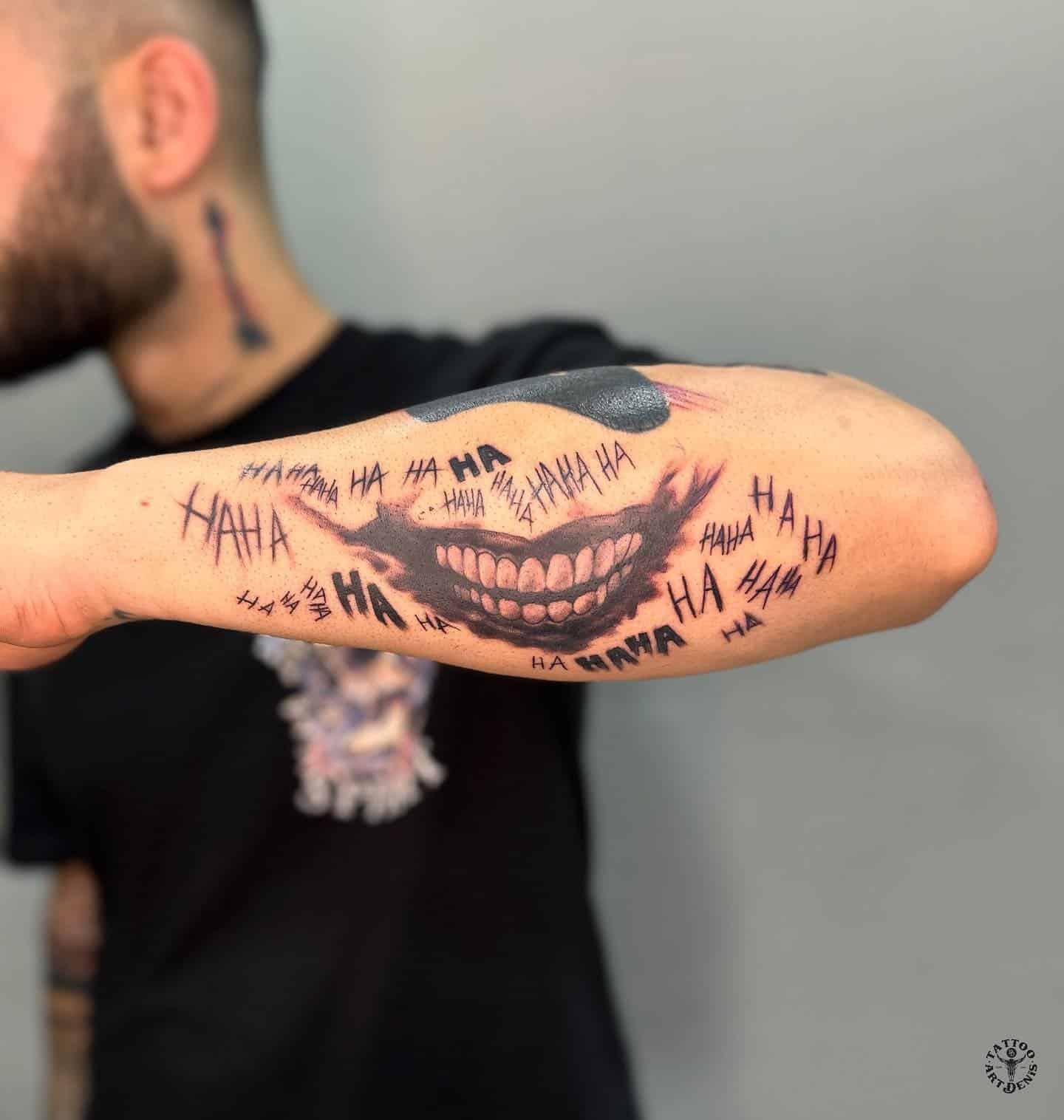 16] Outer Arm Tattoo: Joker Ha Ha Tattoo Design – Playful and Creative Ink