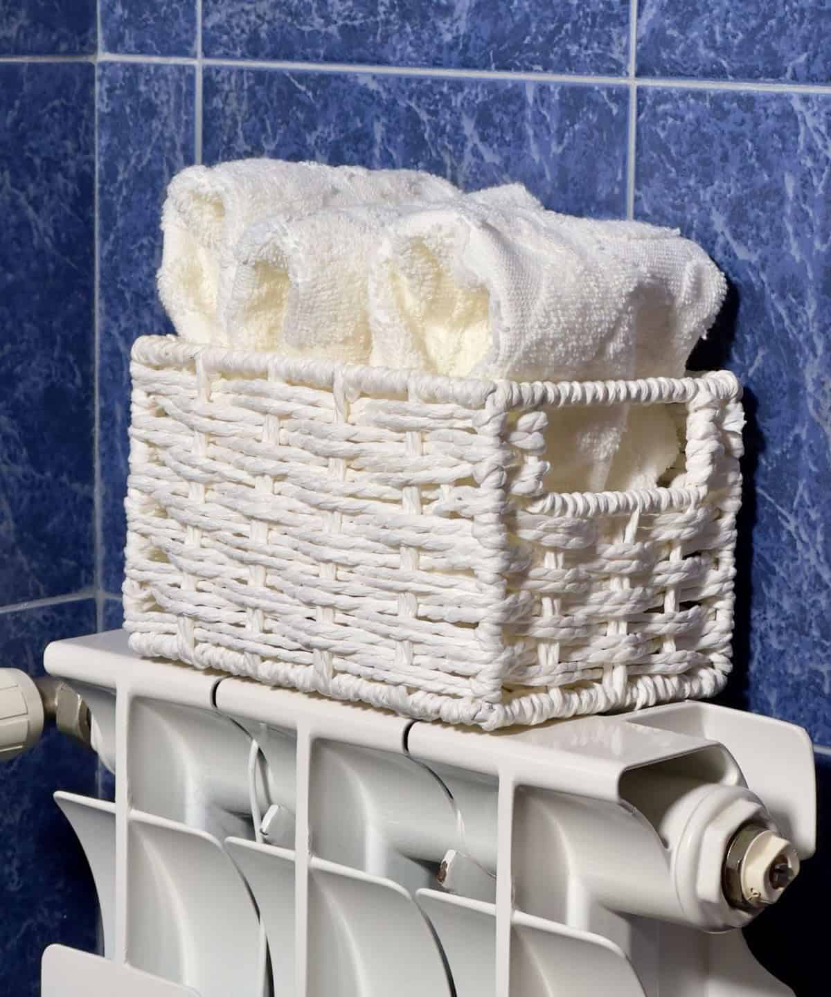 Place A Basket With Hand Towels On The Radiator