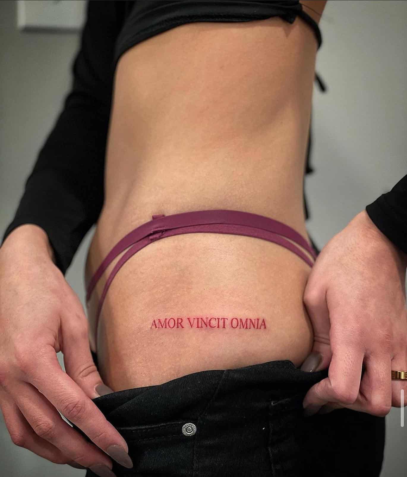 13] ‘AMOR VINCIT OMNIA’ Hip Tattoo: Love Conquers All