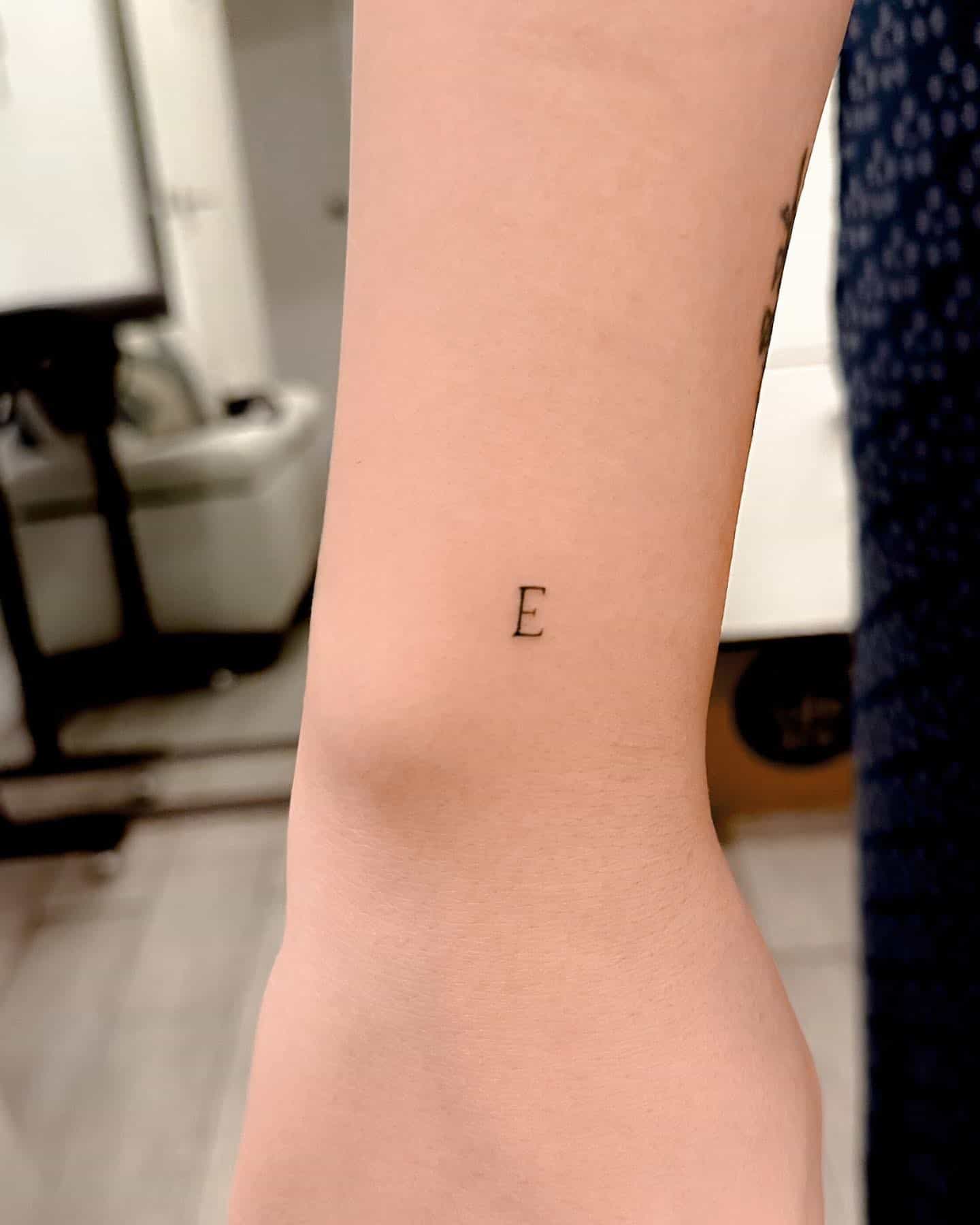 18] Perfect Tiny ‘E’ Letter Tattoo: Subtle Elegance