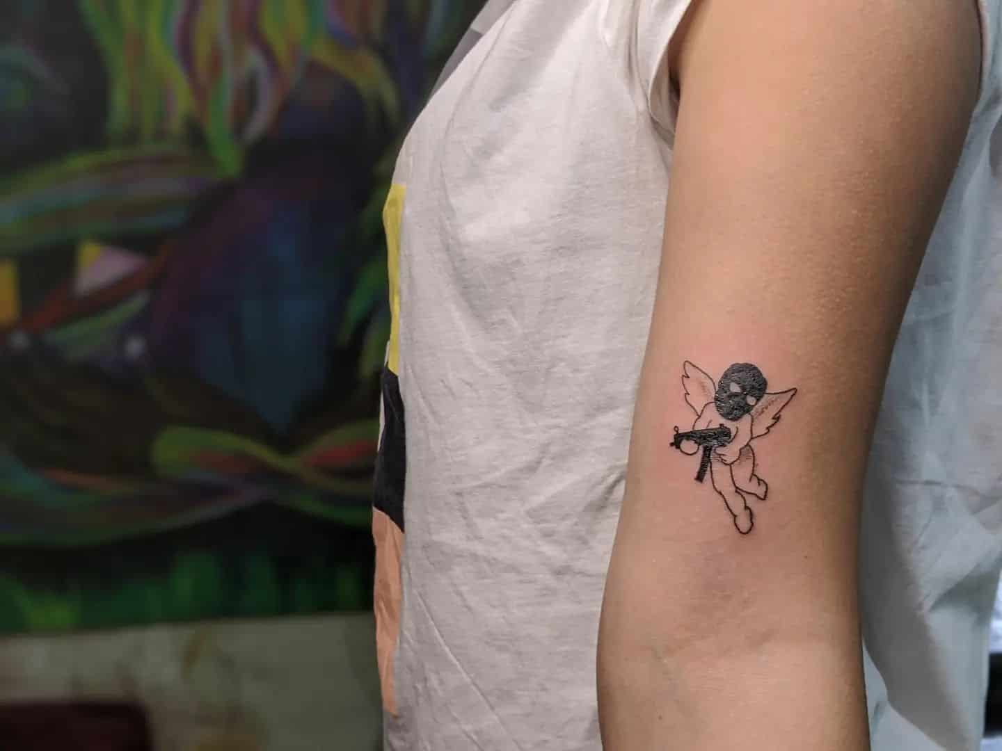 27] Minimalist Angel with Gun Above the Elbow: Symbolism