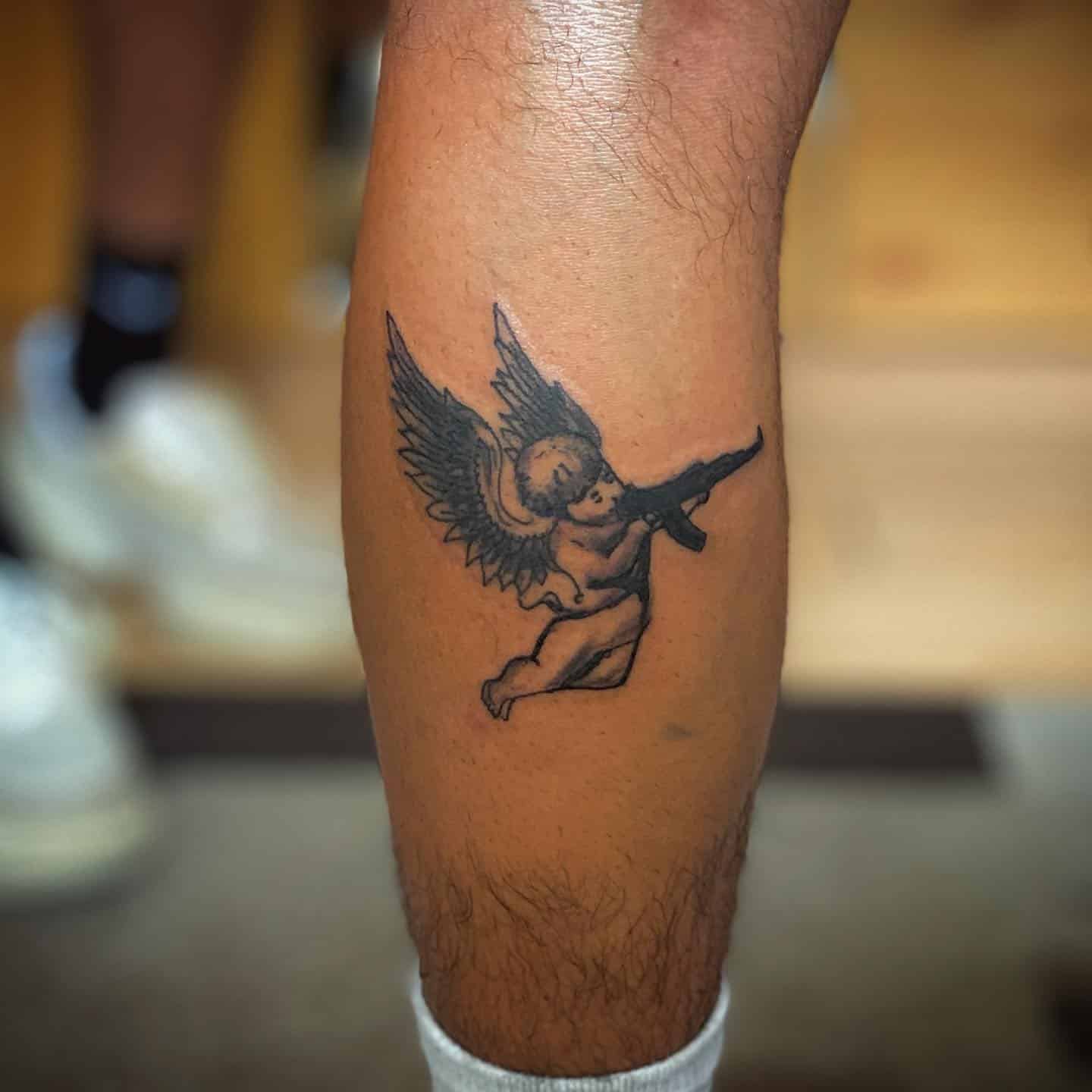 11] Minimalist Flying Angel With Gun Tattoo: Simple and Elegant Design