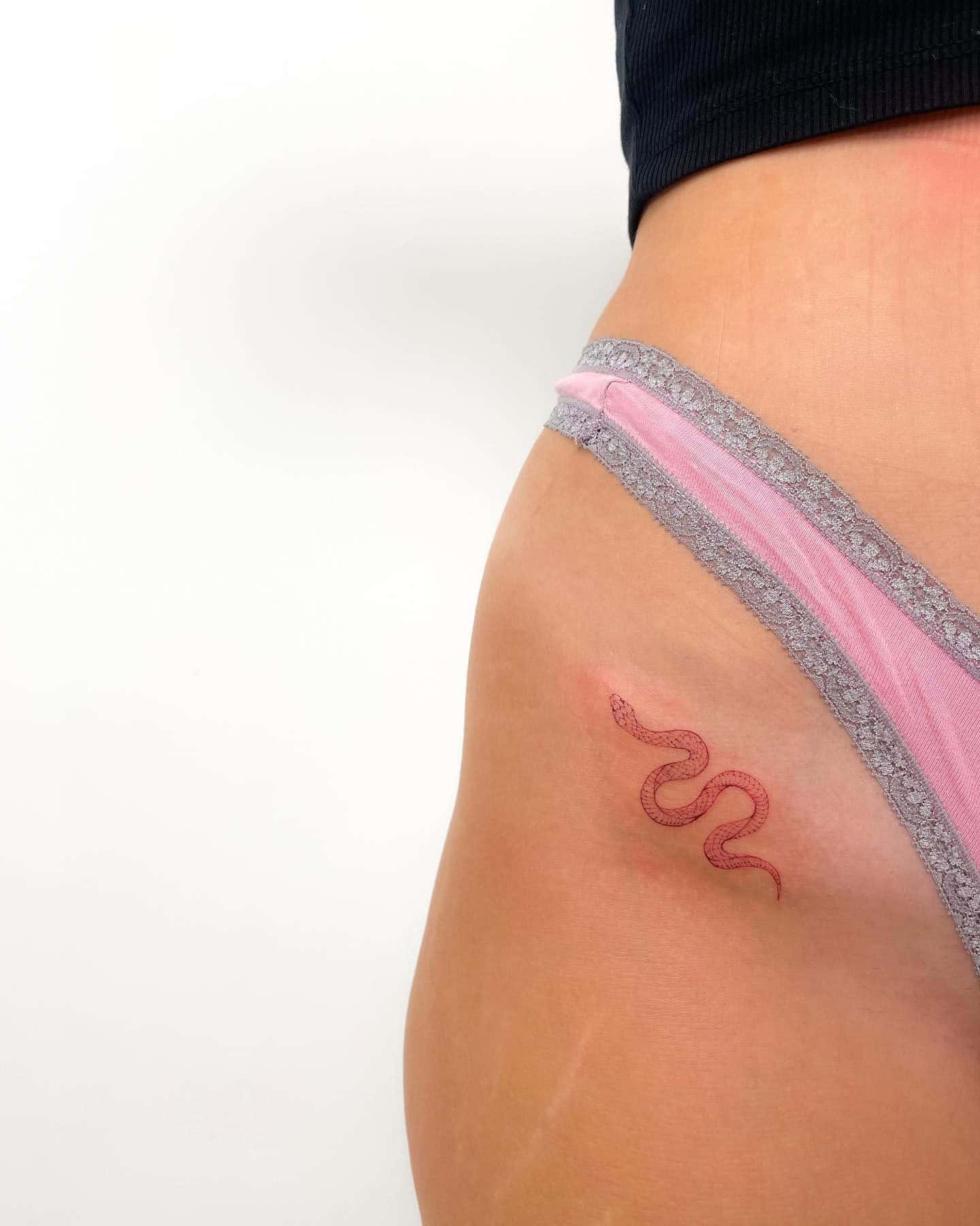 58] Small Red Snake Hip Tattoo: Serpent’s Intriguing Embrace