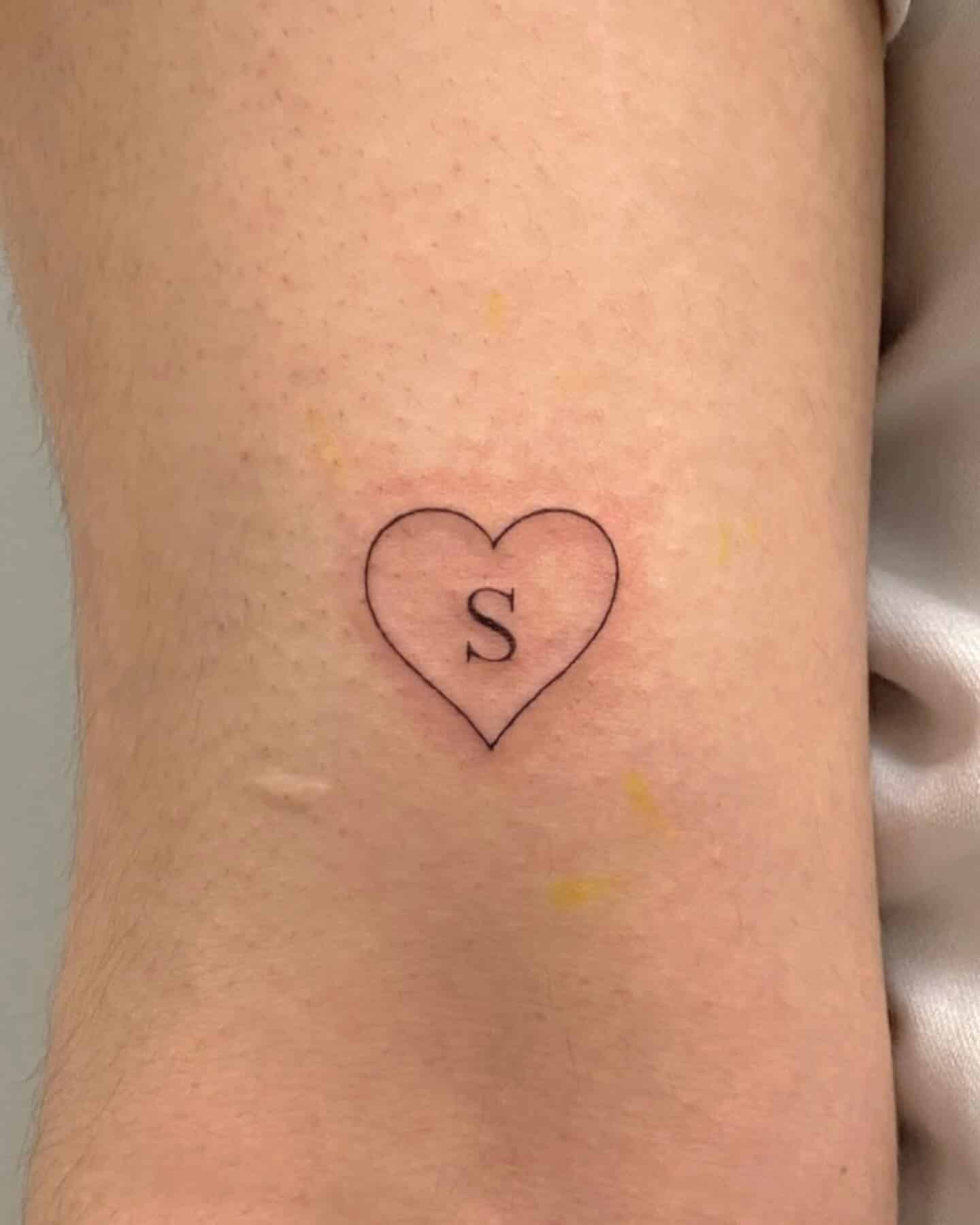 34] Heart Tattoo Above Elbow with ‘S’: Symbolic Heart