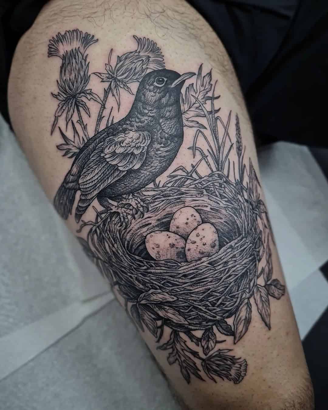 16] Illustrative Large Nest and Blackbird Thigh Tattoo: Botanical Beauty