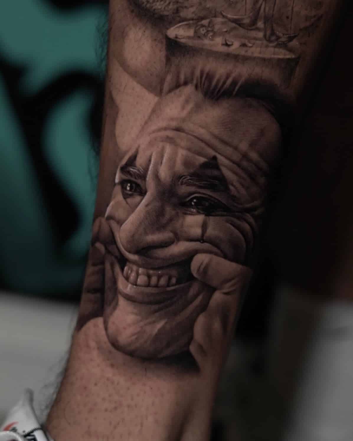 26] Joker Cry and Smile Tattoo on Leg: Emotional and Dramatic Leg Tattoo