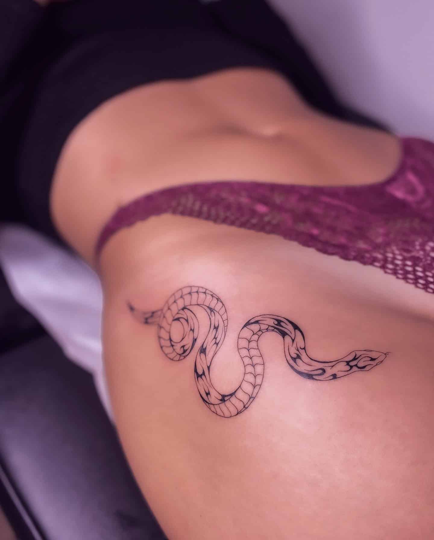 24] Small Snake Hip Tattoo: Sleek Serpent