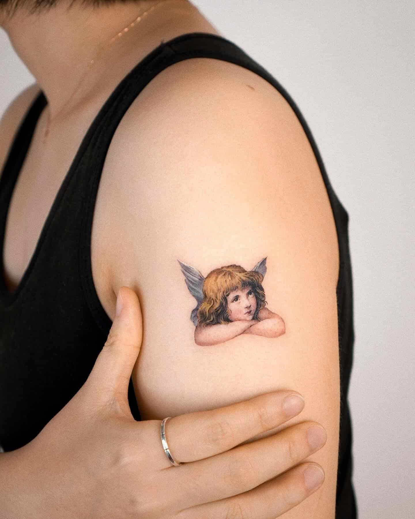 18] Realistic Baby Angel Shoulder Tattoo: Colorful Serenity