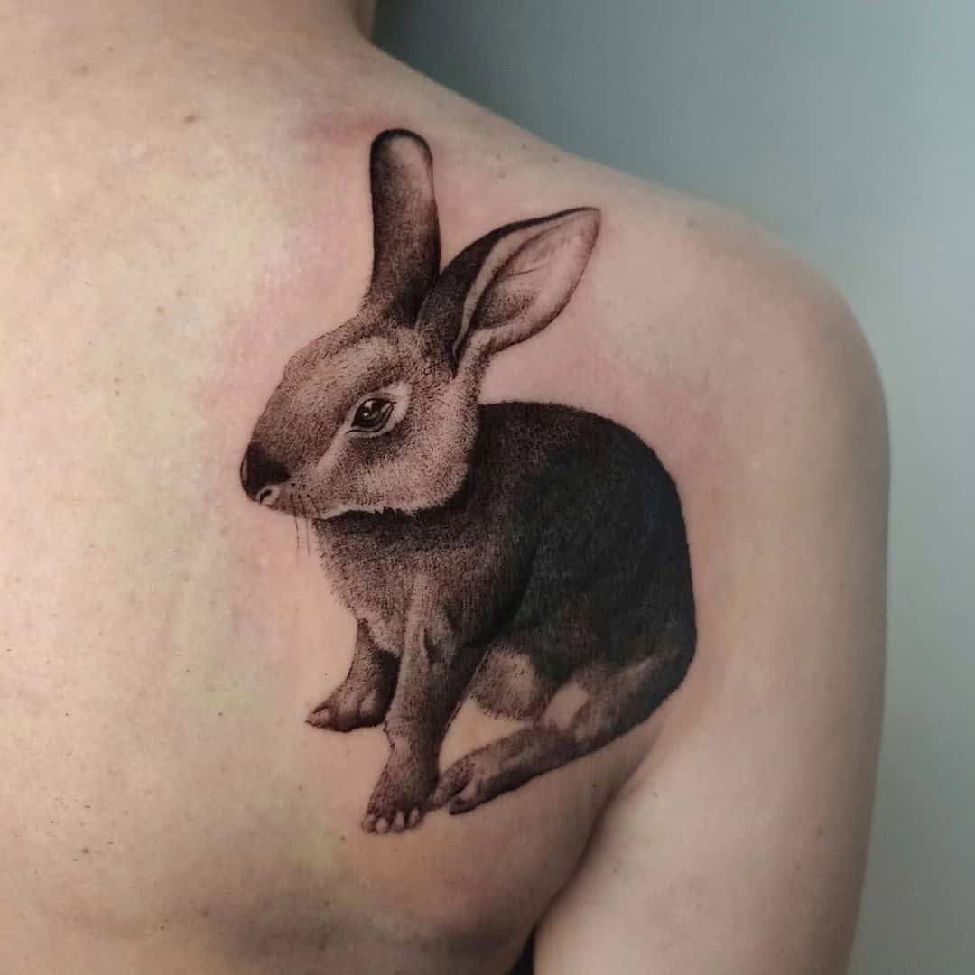 13] Realistic Dark Grey Rabbit Tattoo: Men’s Ink Elegance