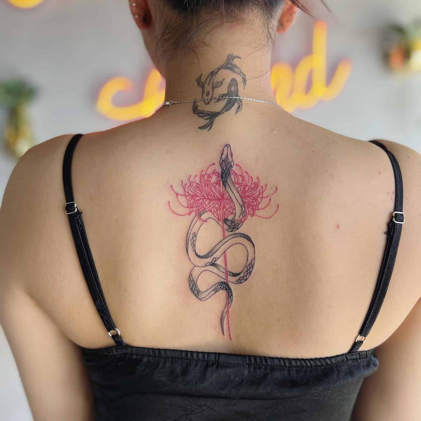 15] Women’s Back Tattoo: Spider Lily and Snake Art