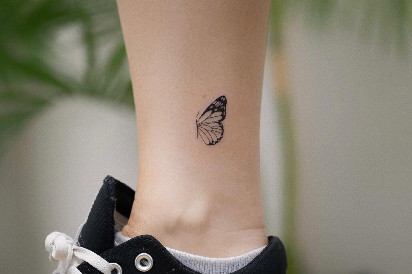 13] Side View Flying Butterfly Leg Tattoo: Traditional Flight