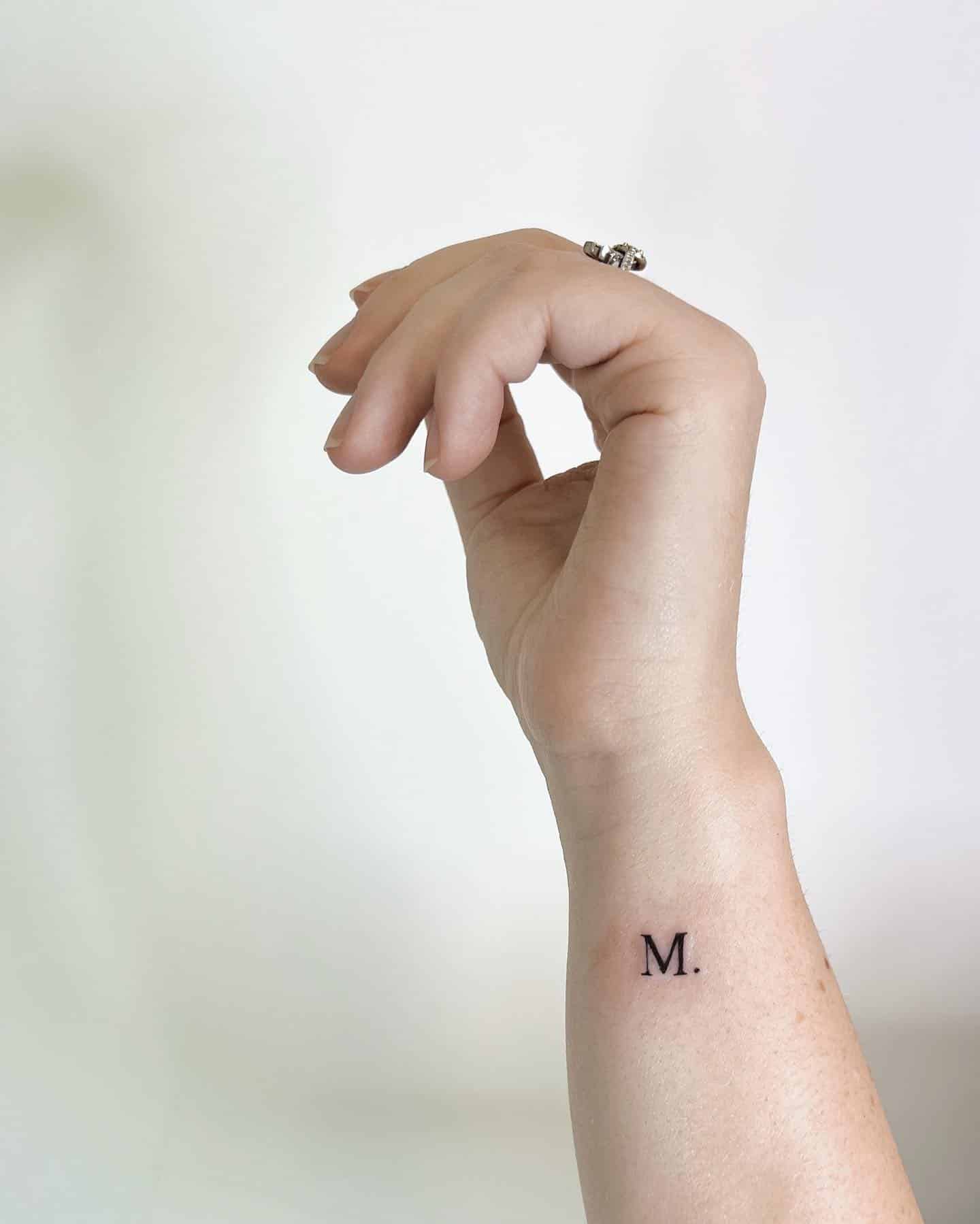 5] ‘M.’ Wrist Tattoo: Stylish Statement