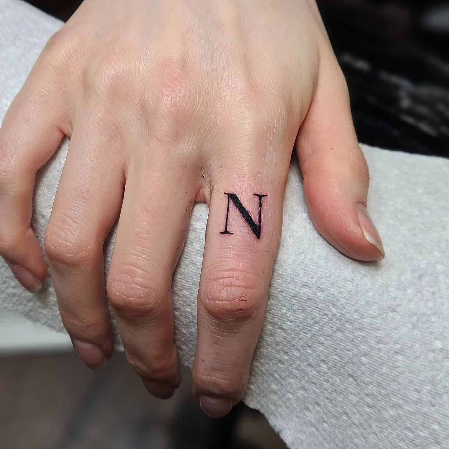 35] Outer Finger ‘N’ Letter Tattoo: Finger Accent