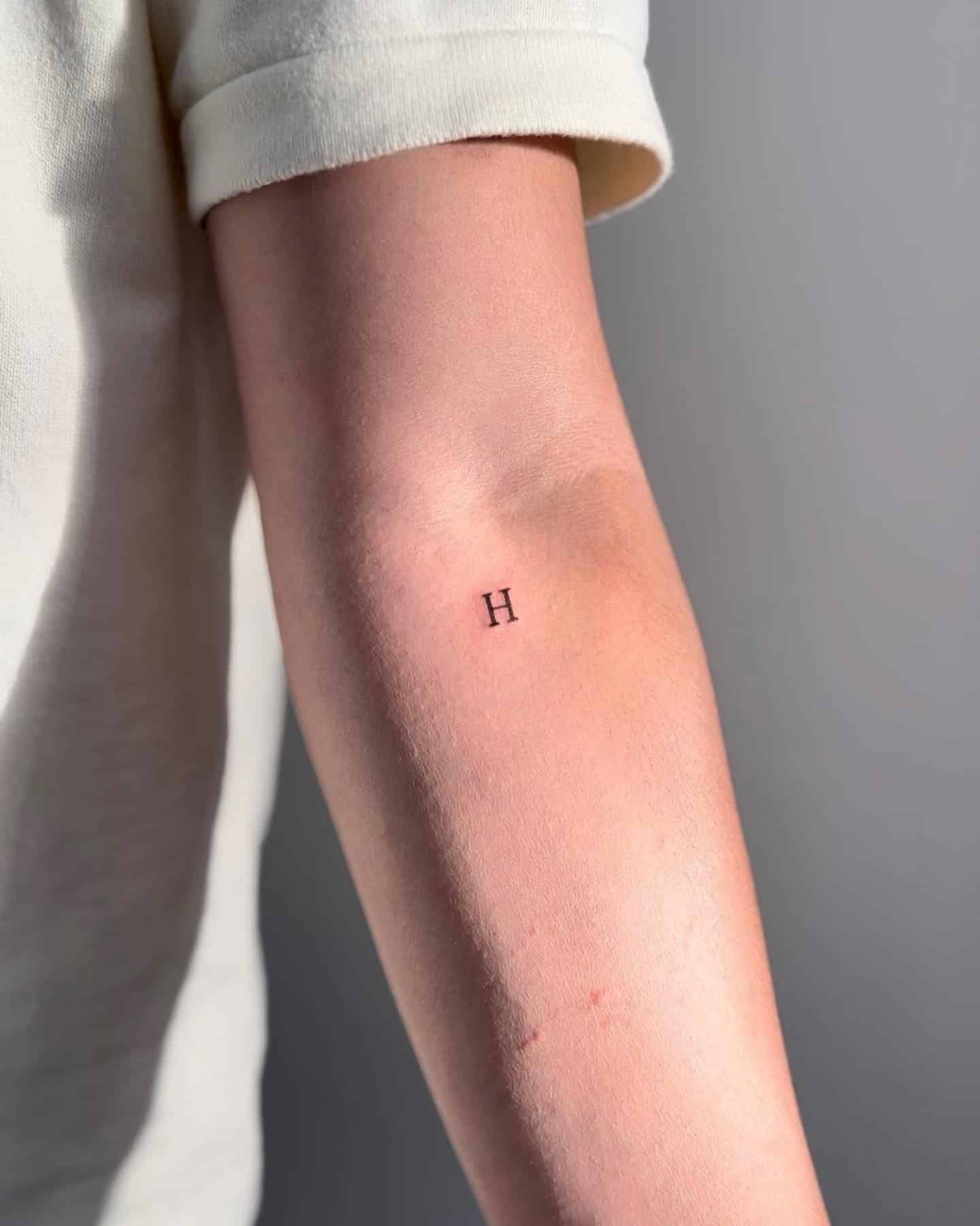 19] ‘H’ Lettering Tattoo: Arm Adornment