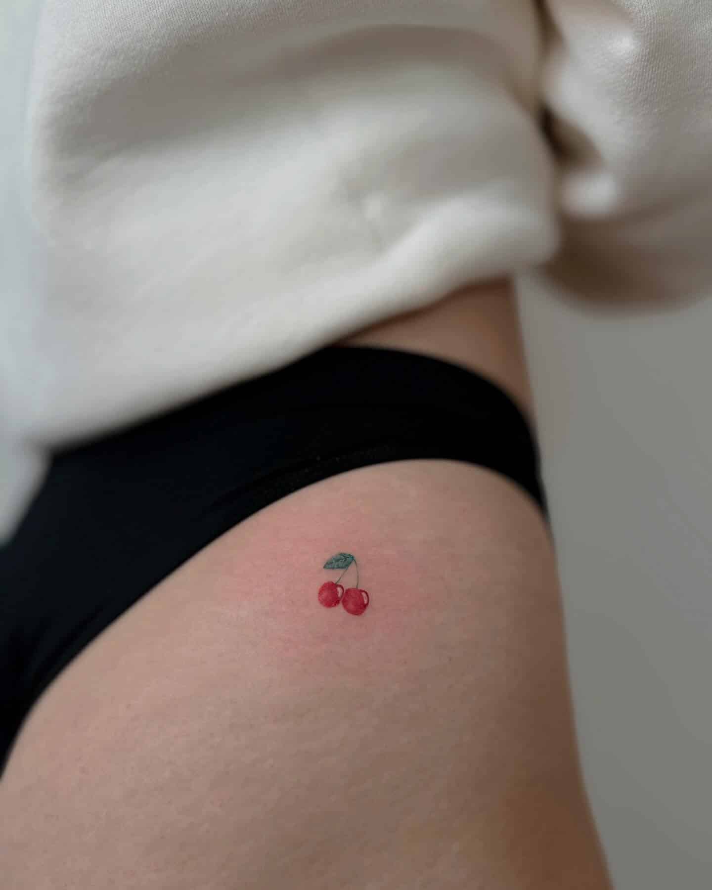 10] Colorful Cherry Hip Tattoo: Cherry Delight