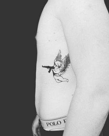 10] Mini Angel with Gun Tattoo: Tiny and Meaningful Tattoo Inspiration