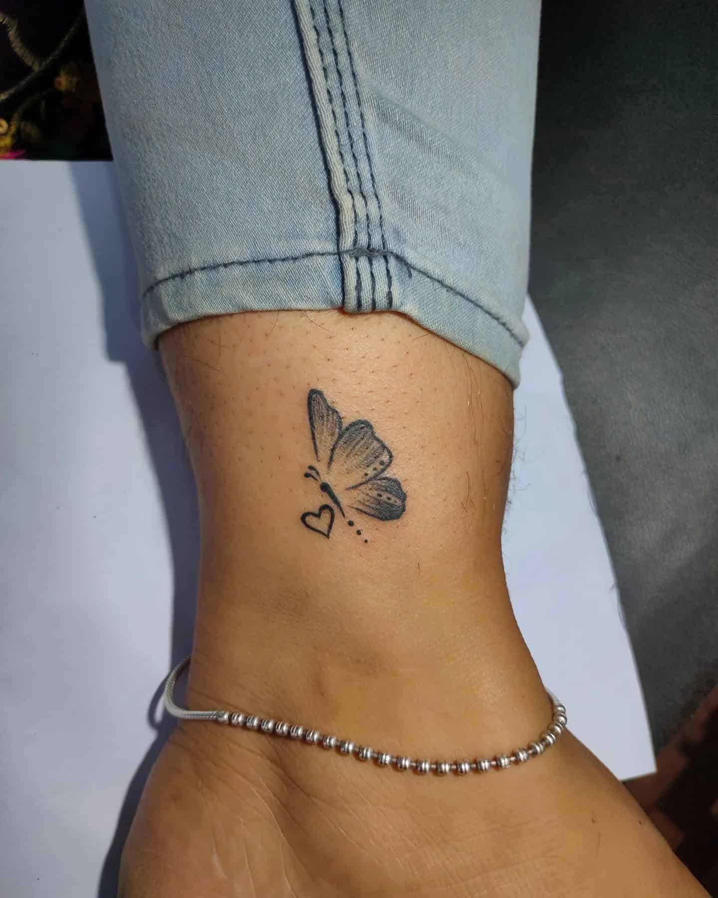 23] Flying Butterfly and Outline Heart Tattoo: Fluttering Elegance