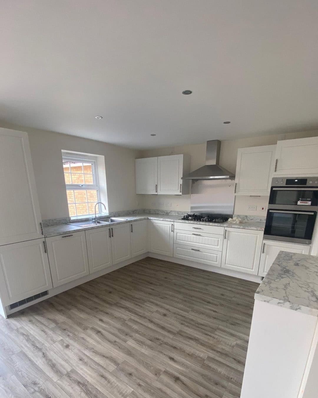 BEFORE: SPACIOUS KITCHEN WITH ALL WHITE CABINETS