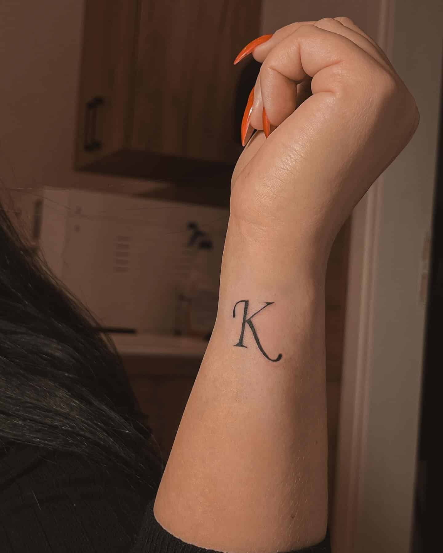 32] Side ‘K’ Letter Tattoo: Forearm Expression