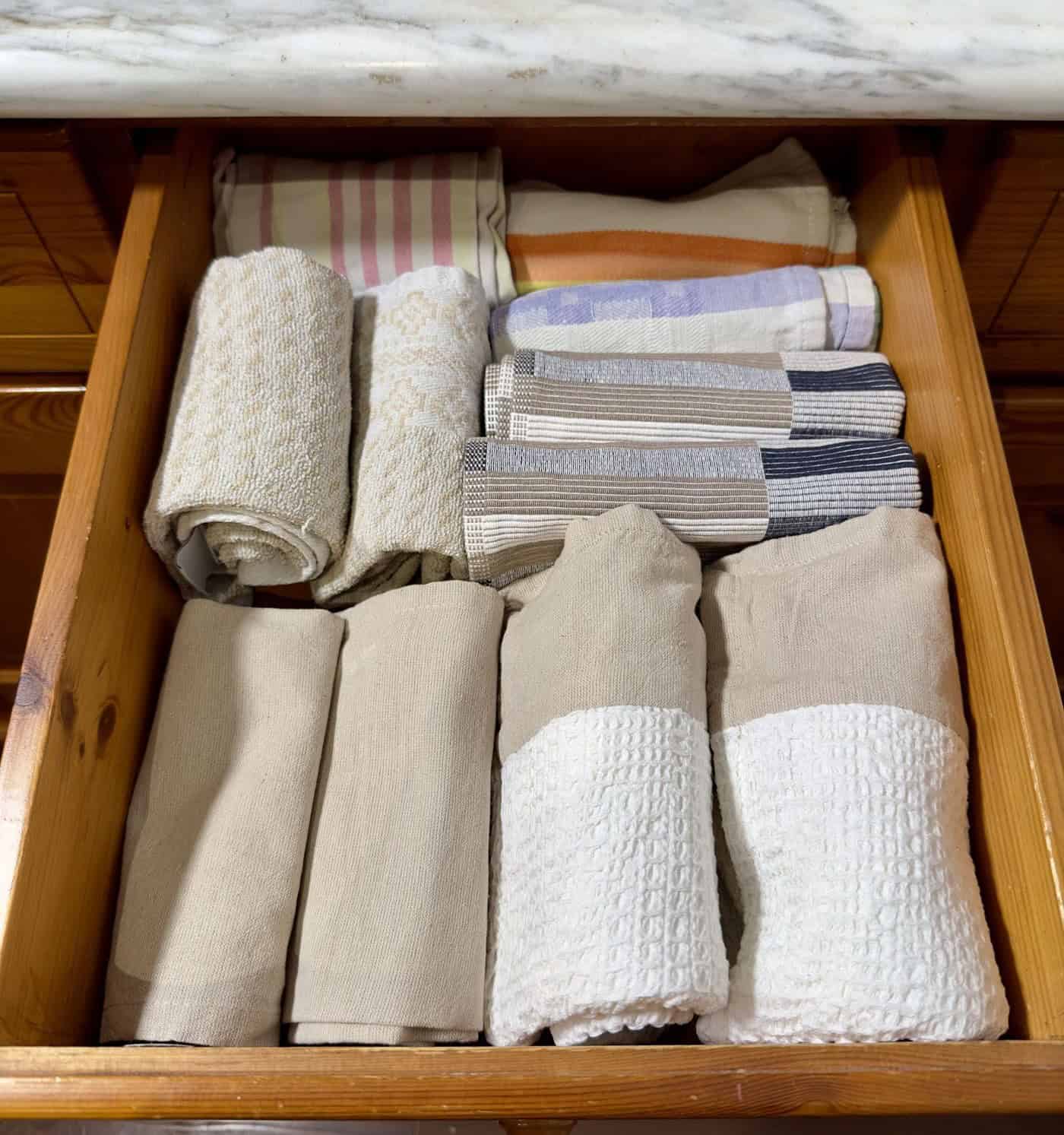 Roll Up Your Kitchen Towels To Store In A Drawer