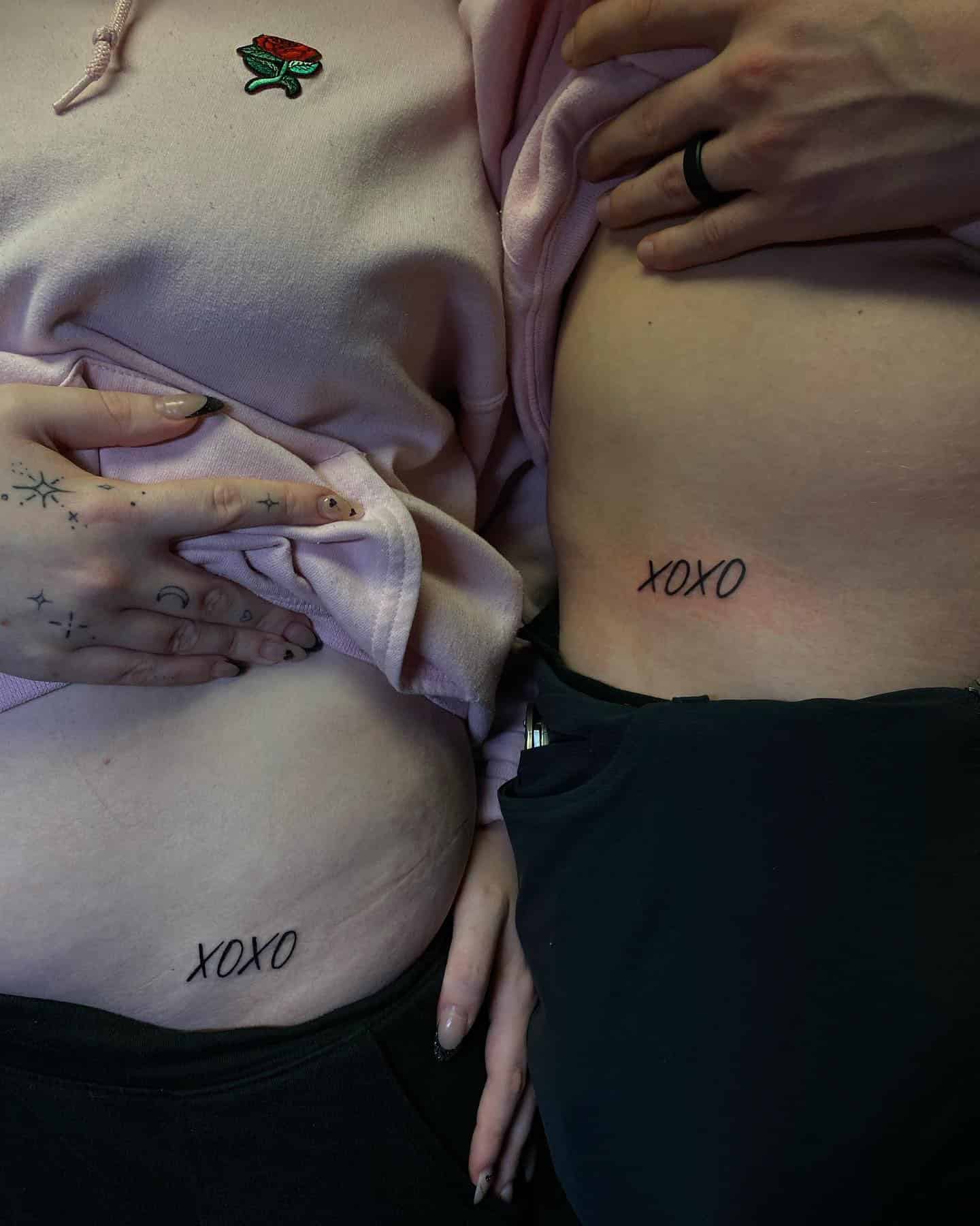 47] Matching Couple ‘XOXO’ Hip Tattoo: Symbol of Affection