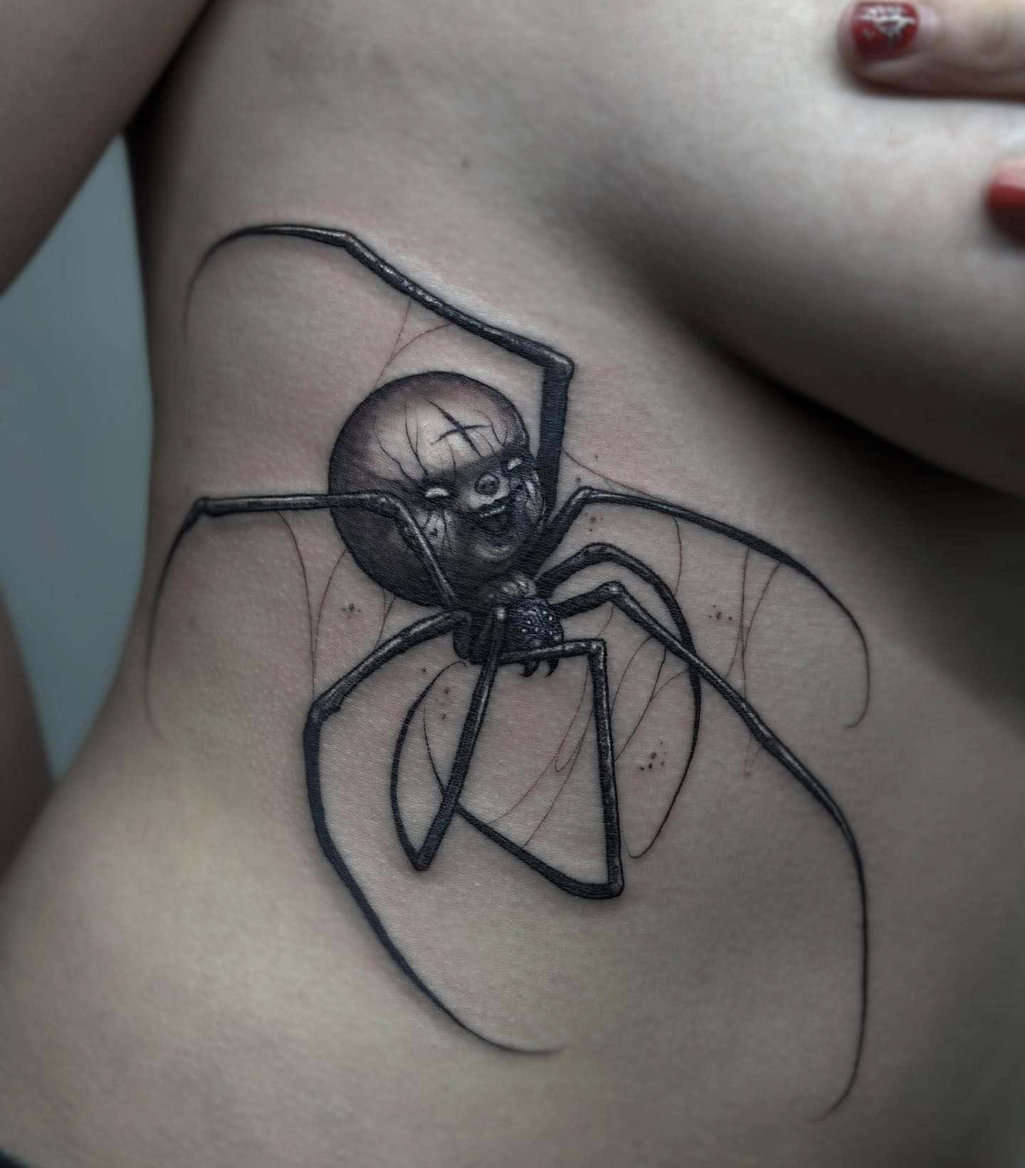 32] Custom Angry Spider Rib Tattoo: Arachnid Anger