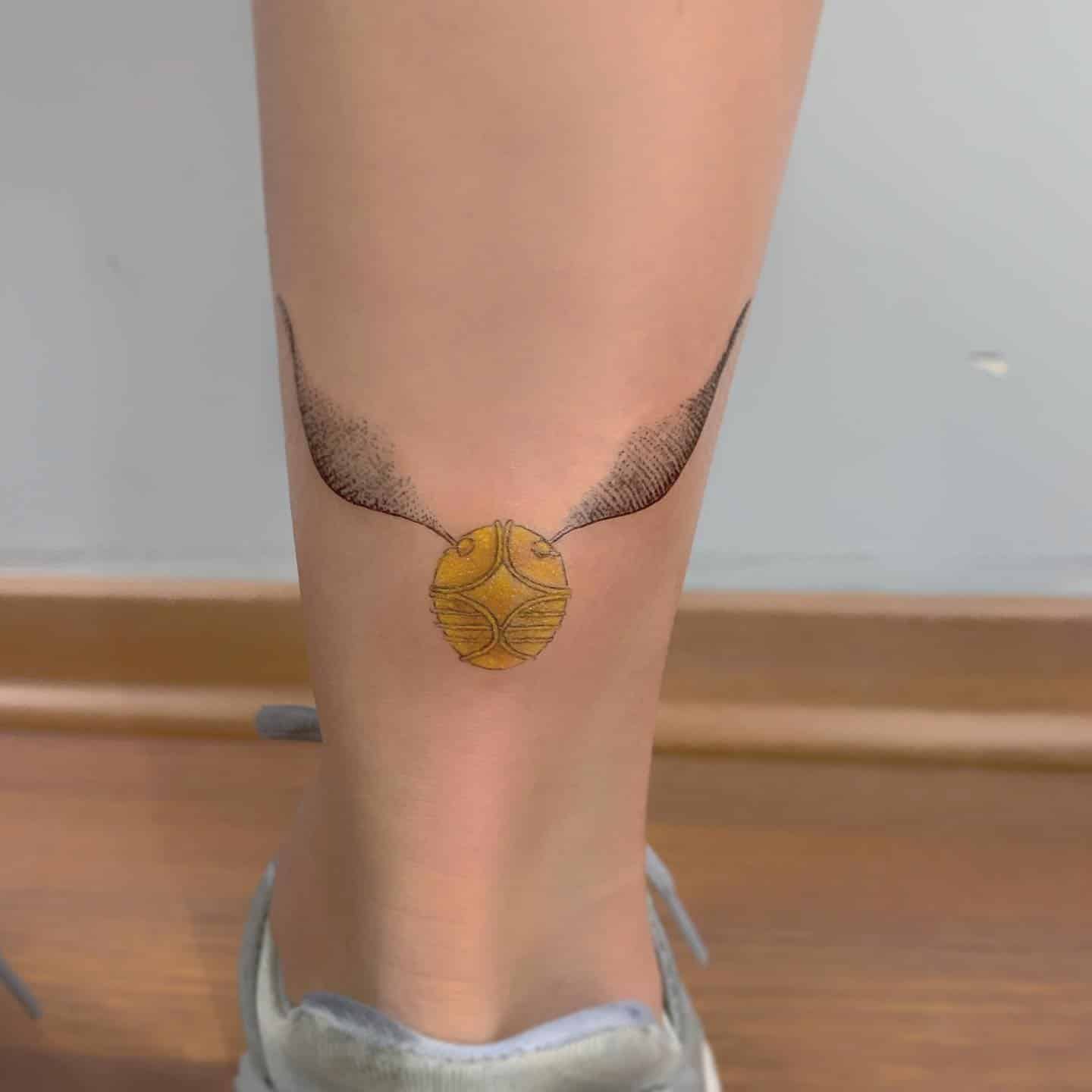 18] Back of Lower Leg Golden Snitch Tattoo: Subtle Enchantment