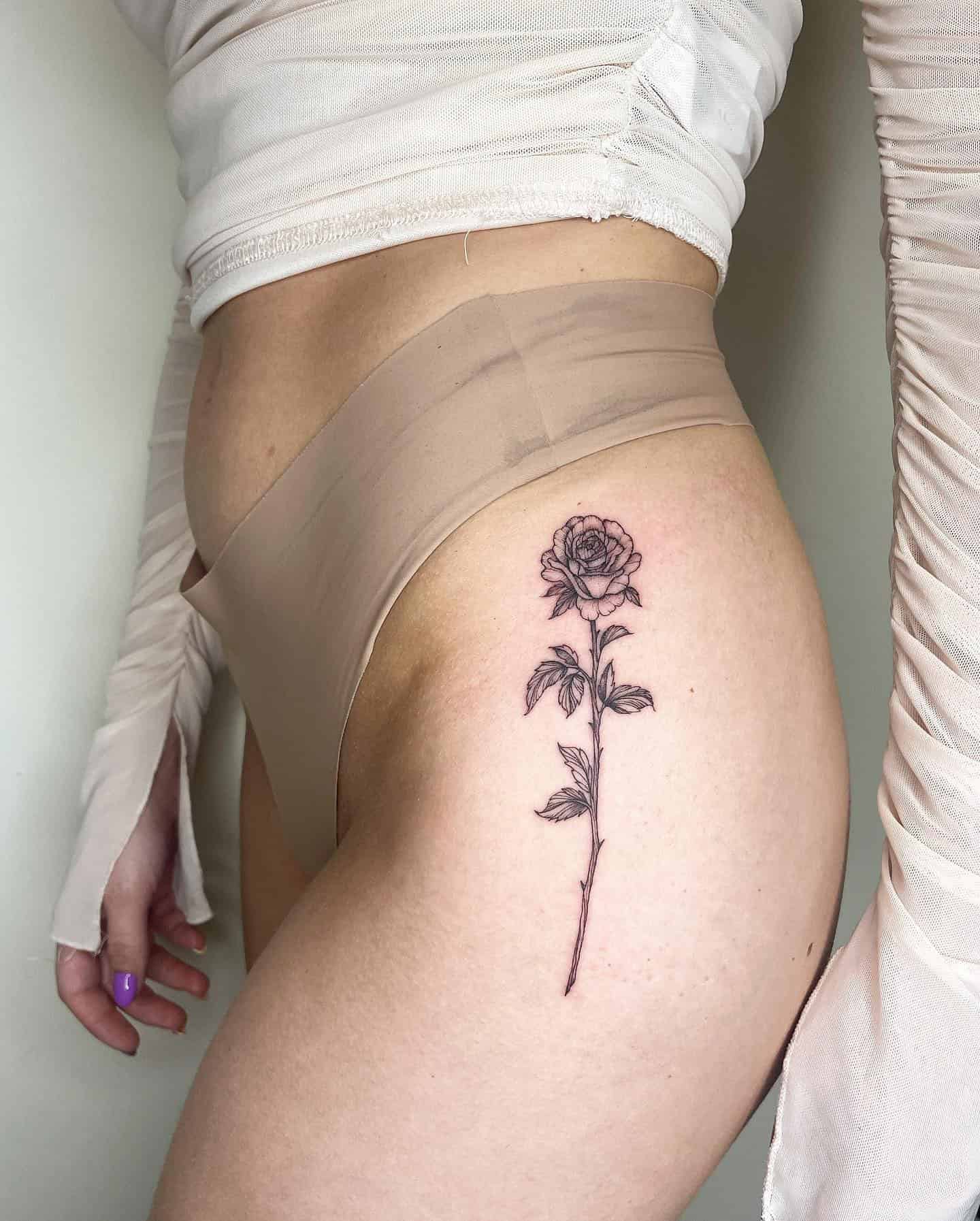 40] Elegant Rose Hip Tattoo: Rose Whispers