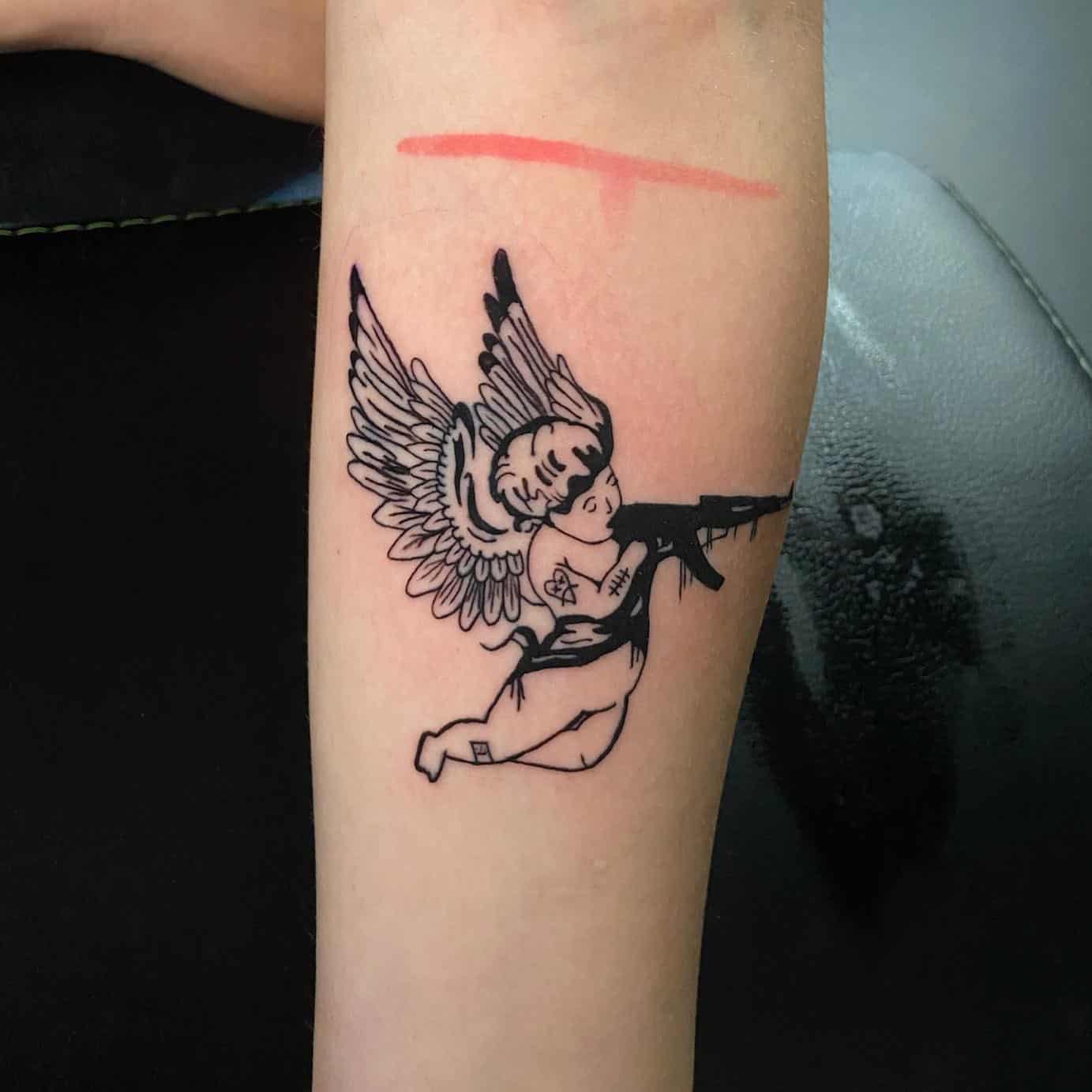 18] A Small Angel Tattoo Holding an Ak47: Symbolism and Intriguing Ink