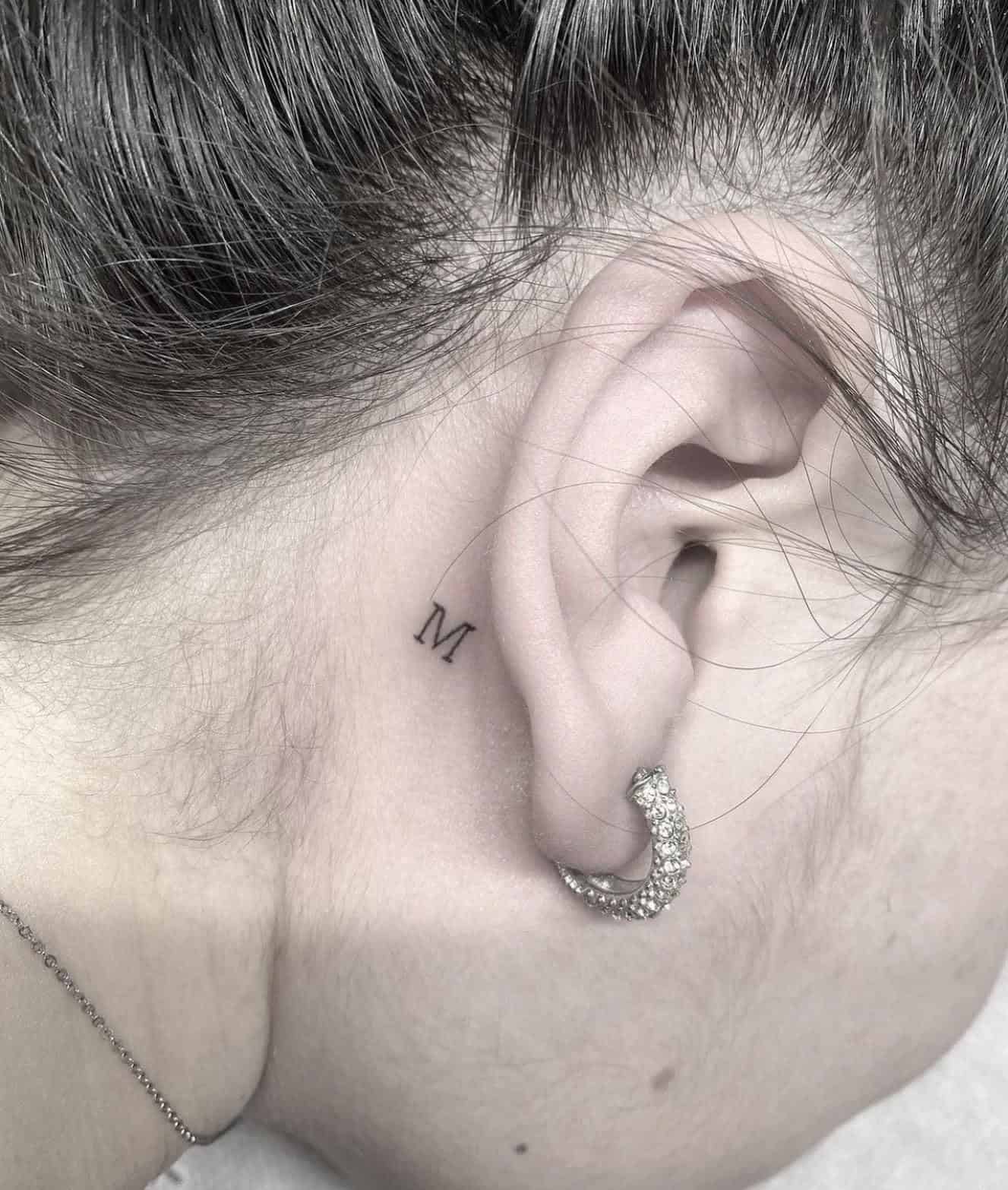 7] ‘M’ Behind the Ear Tattoo: Whispers of Elegance