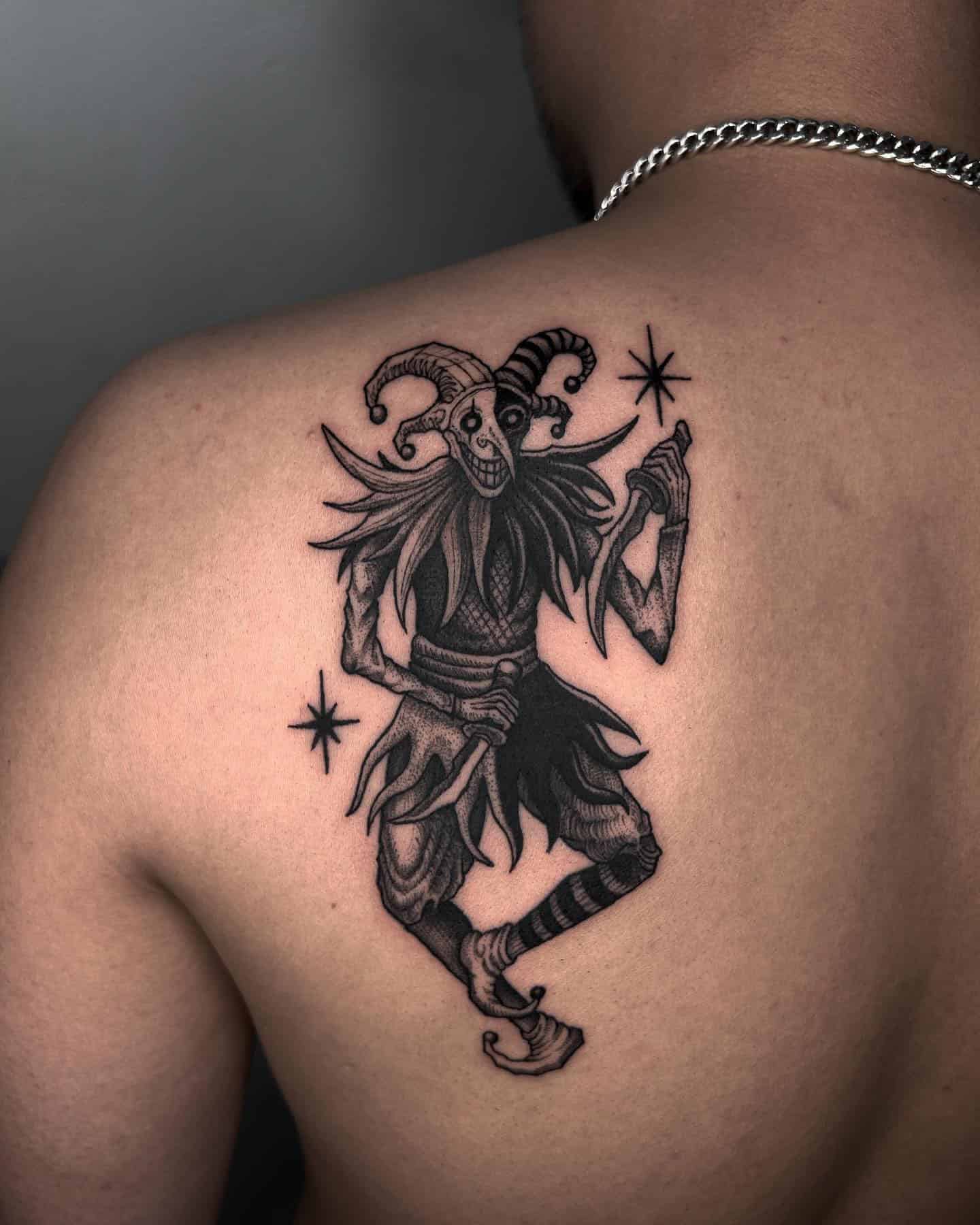 10] Black Joker Holding Knife Tattoo on the Back of the Shoulder