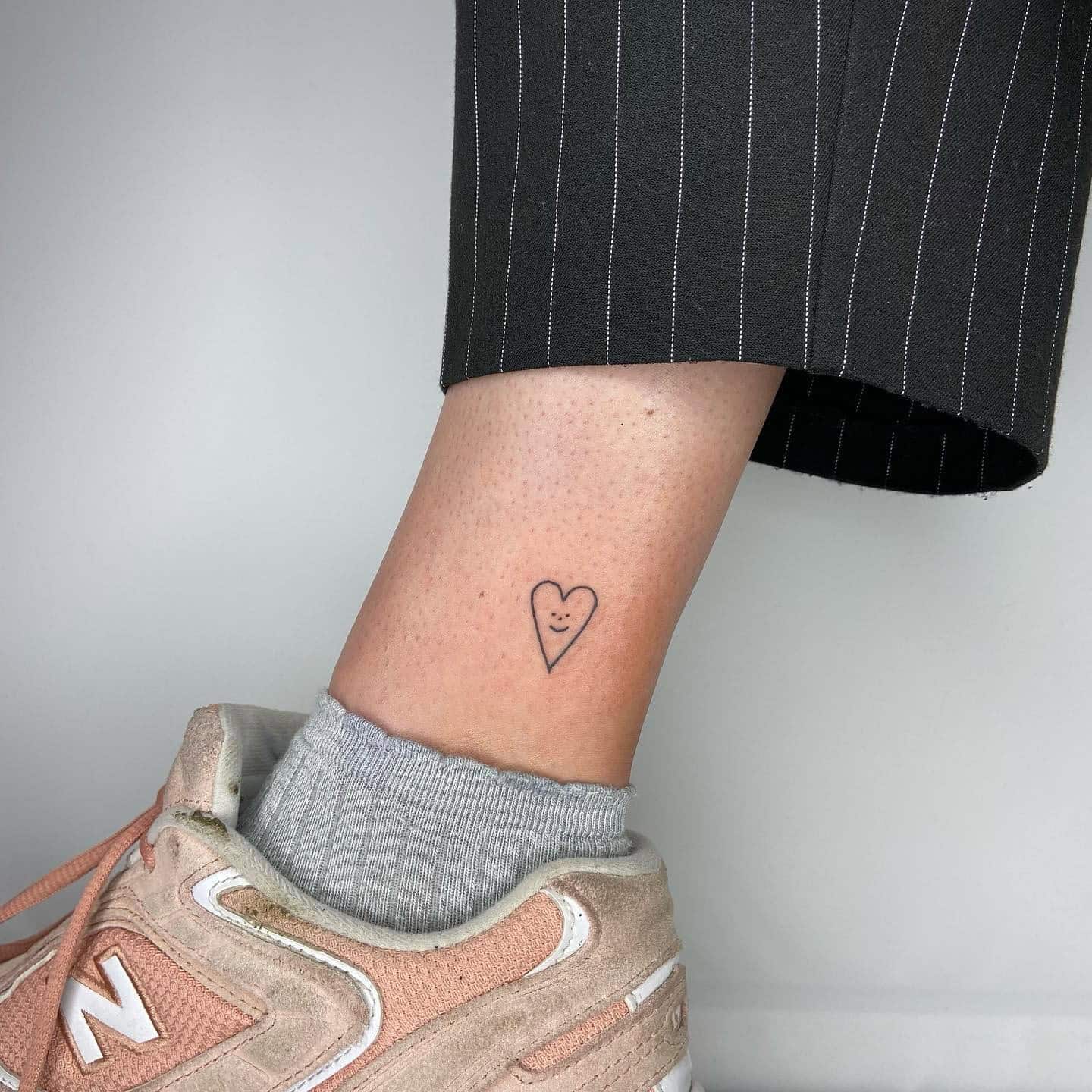 59] Smiling Heart Ankle Tattoo: Heartfelt Joy