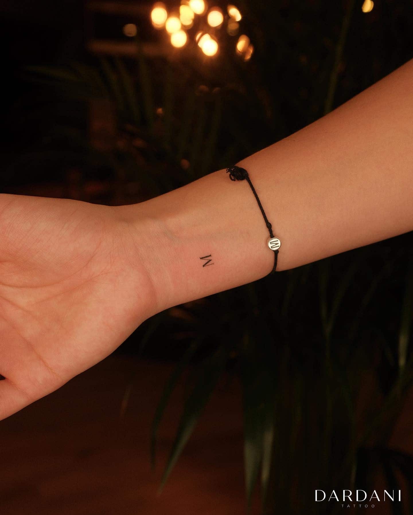 17] Mini ‘M’ Letter Tattoo: Inner Elegance