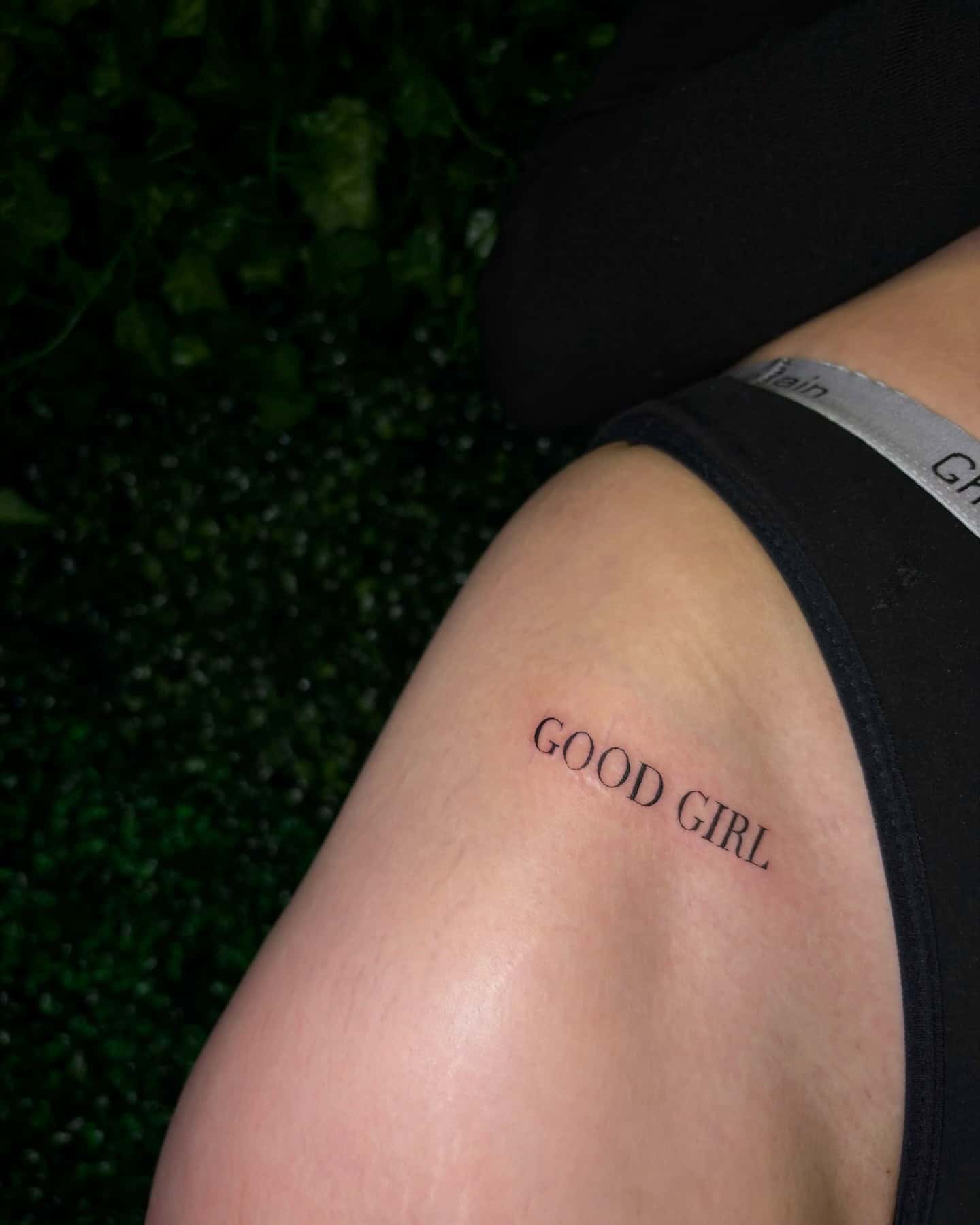 31] ‘GOOD GIRL’ Text Tattoo on Hip: Rebel Chic