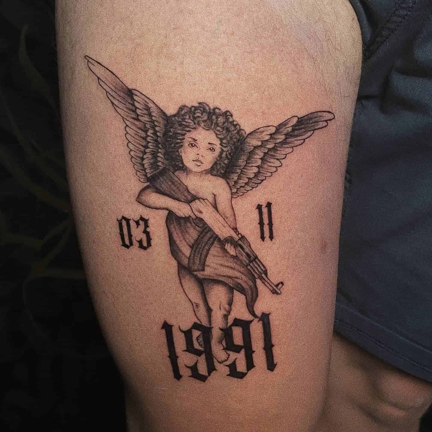 25] Angel with Gun Thigh Tattoo: Personal Tribute