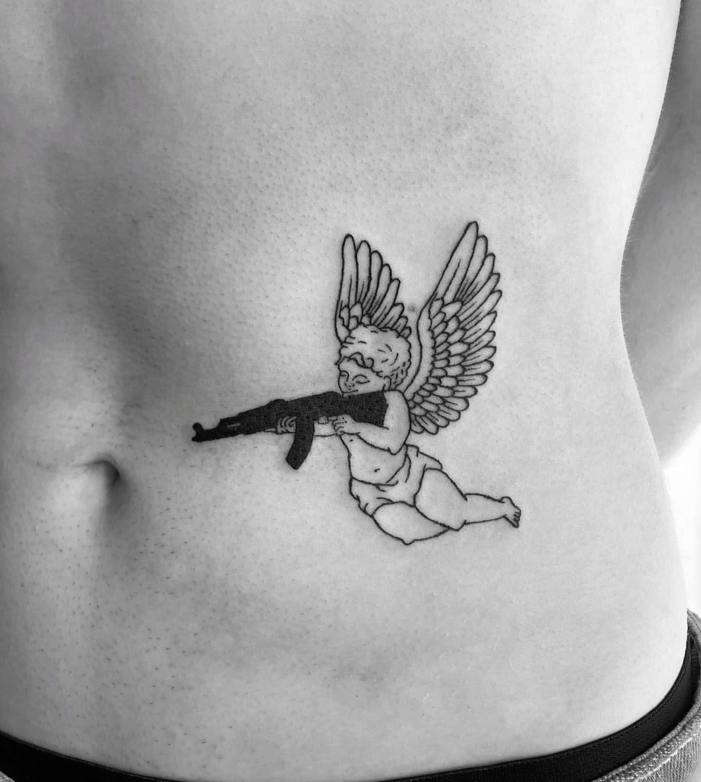 32] Angel with Gun on Side Stomach: Fierce Elegance