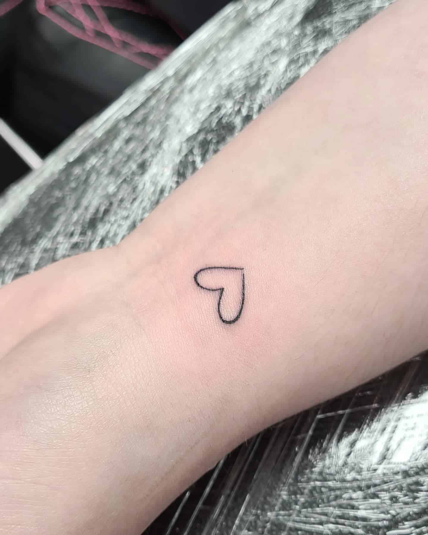 24] Cutest Tiny Black Tattoo: Wrist Heart Outline